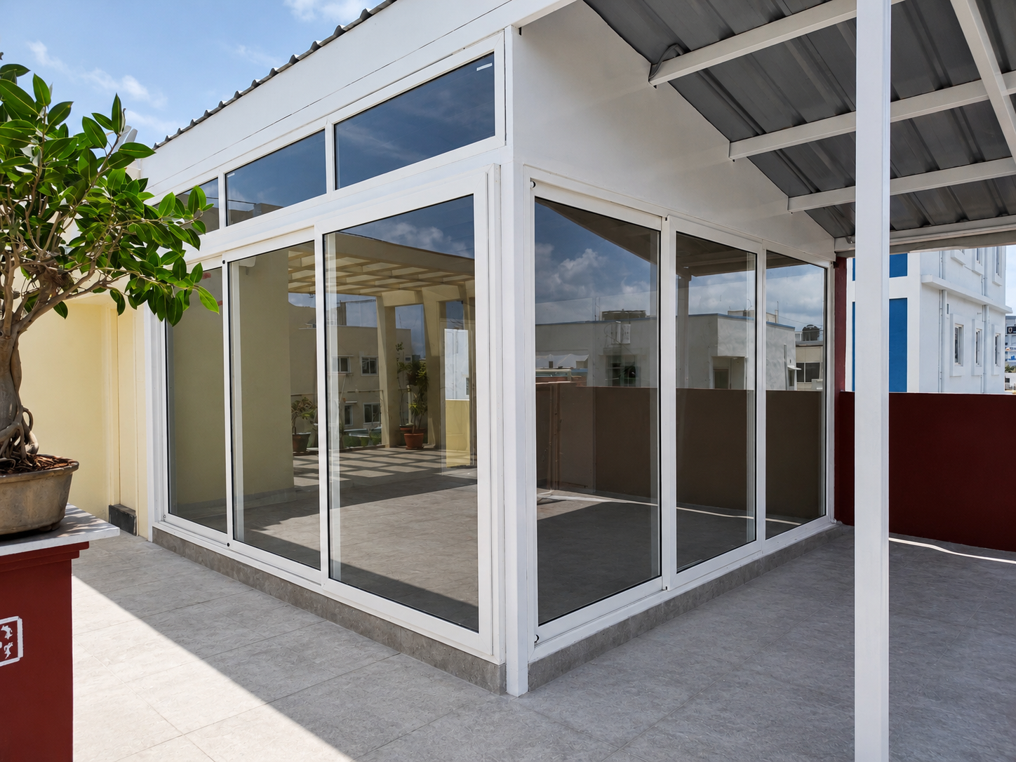 Mason uPVC combination installation — L-section 3-track rooftop enclosure with fixed transoms and sliding panels