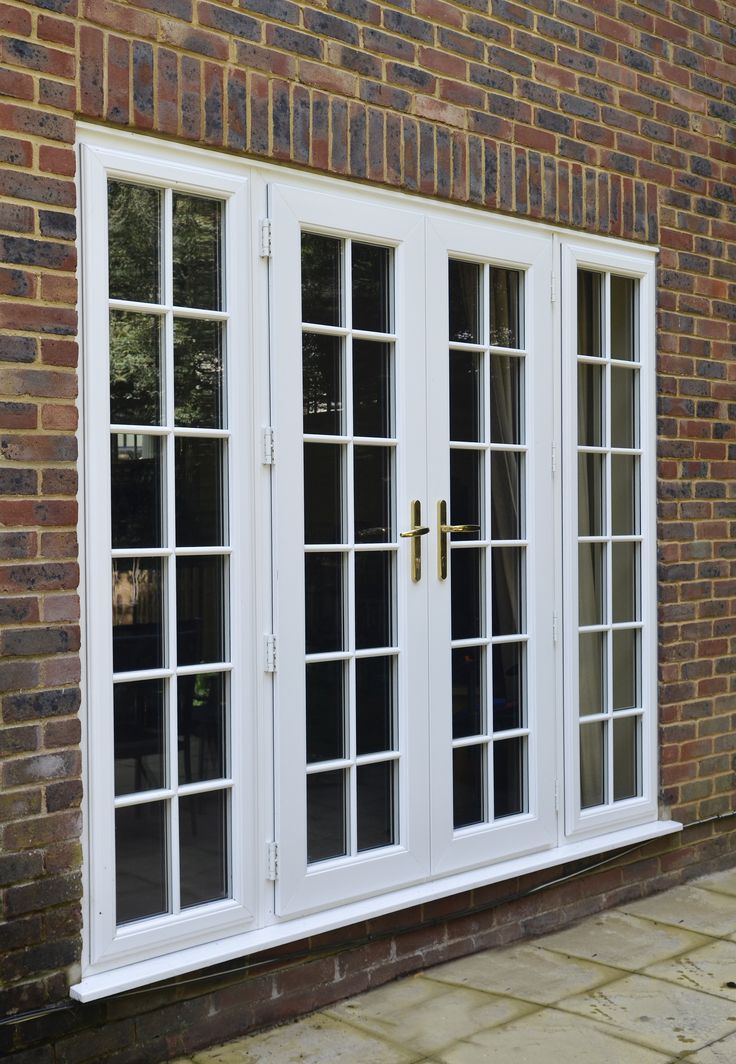 White uPVC French doors with Georgian bars and brass handles