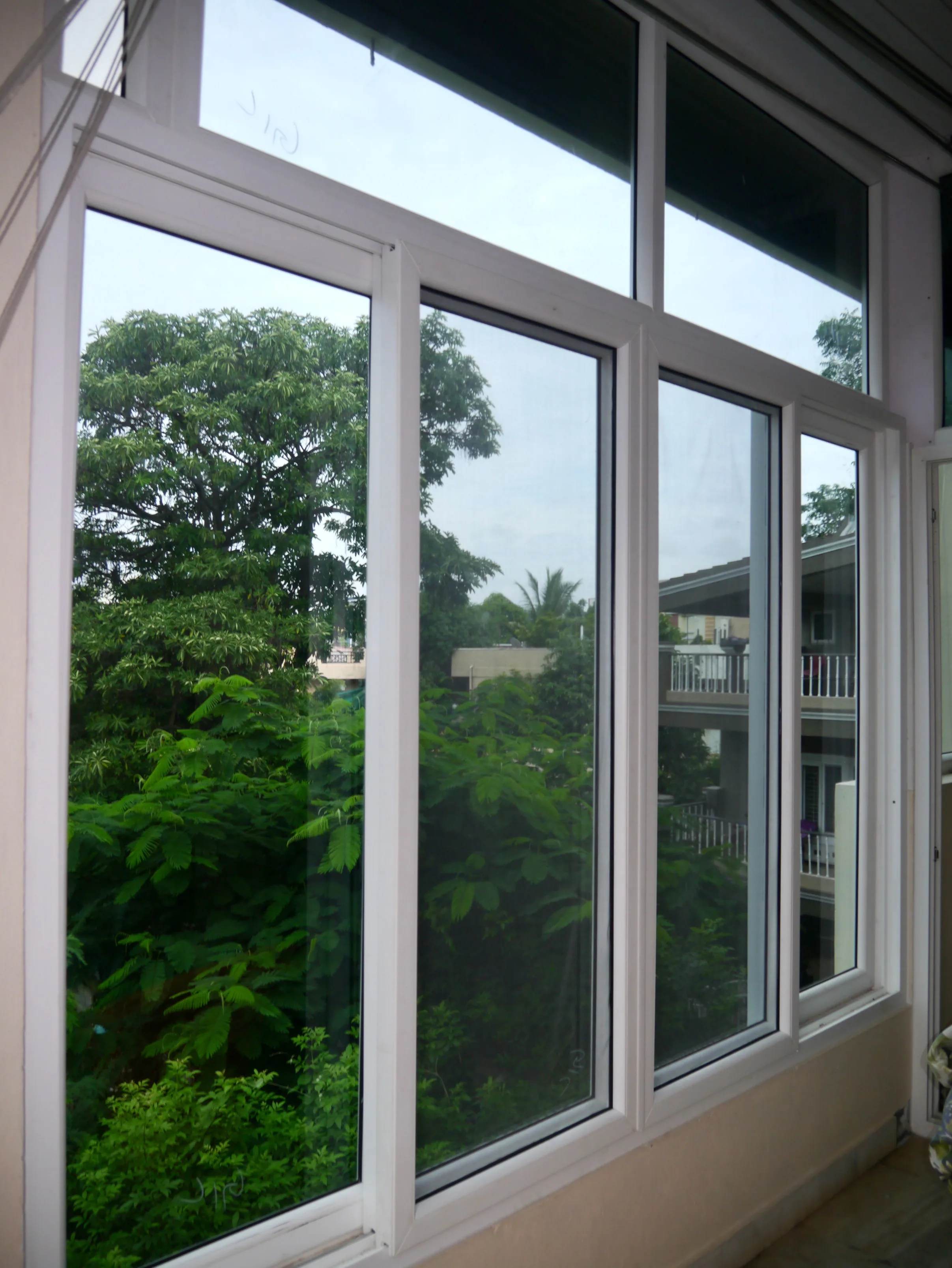 Balcony closing with uPVC sliding windows in a Hyderabad apartment — Mason uPVC